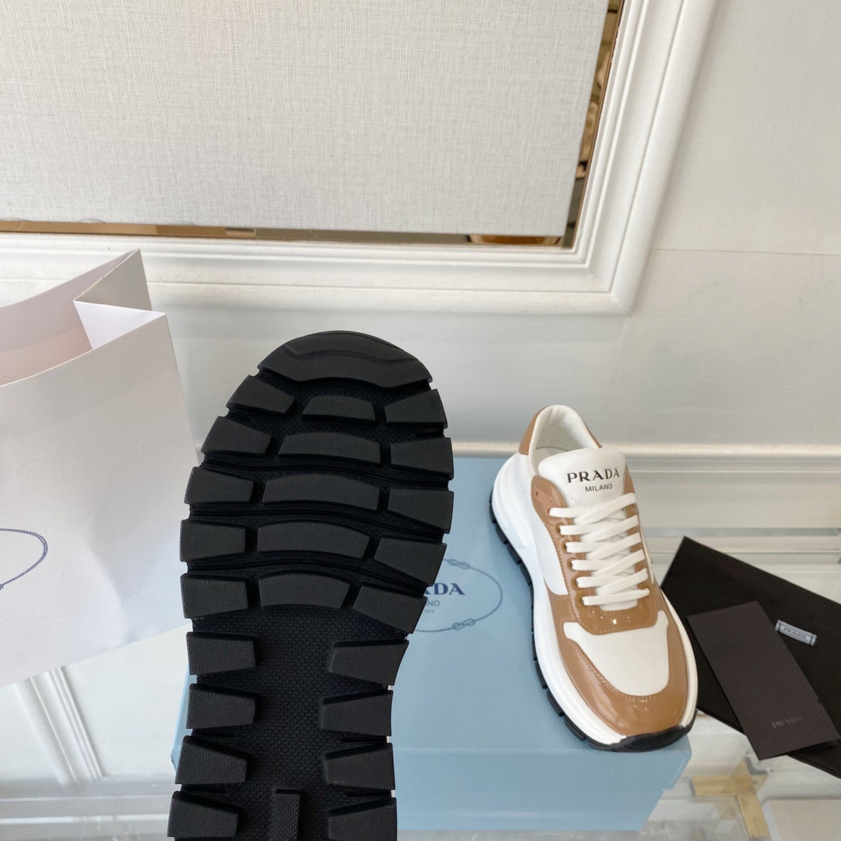 PRADA 25S THICK SOLE SNEAKER IN WHITE AND BROWN CALFSKIN
