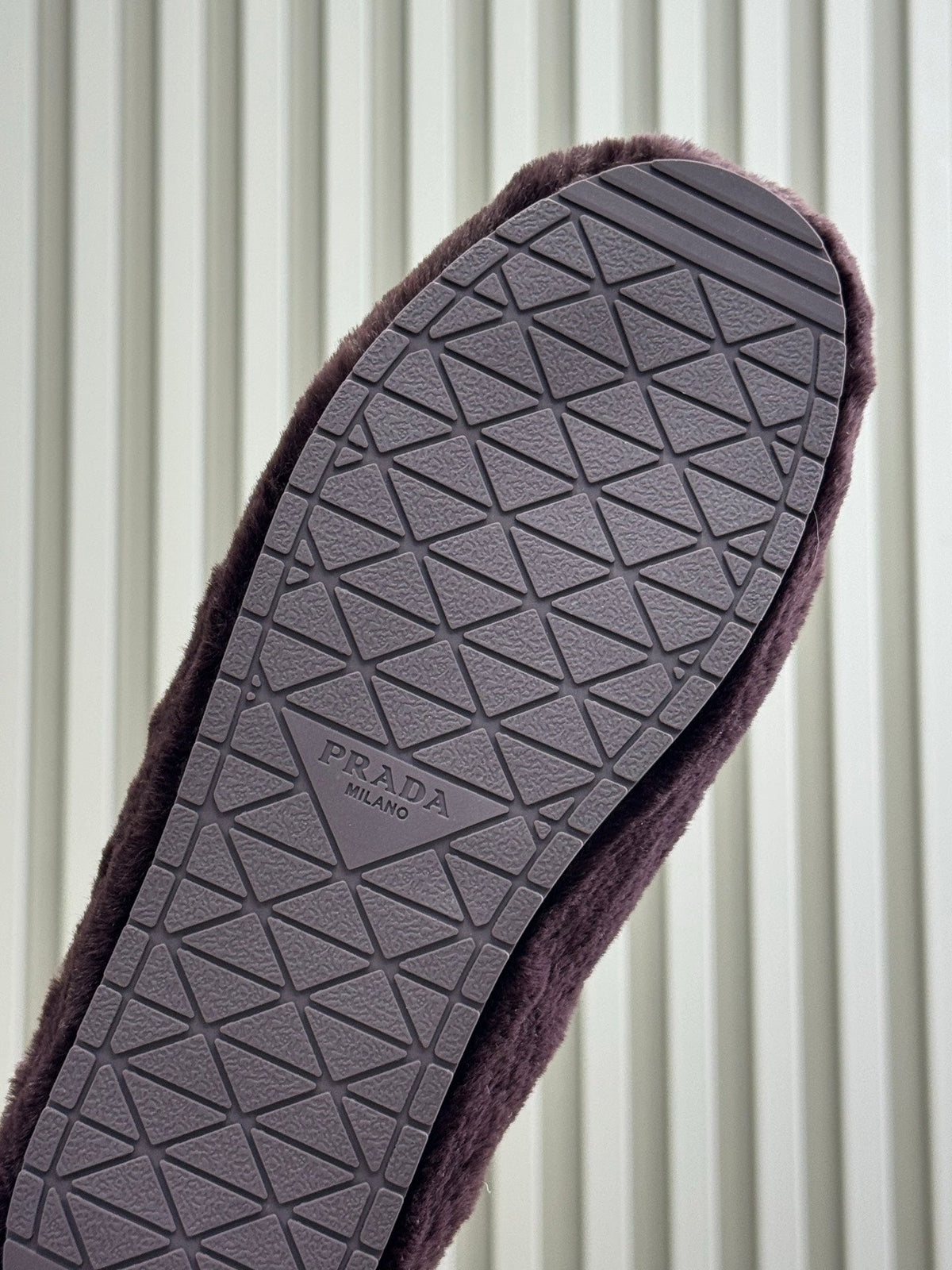 PRADA 25S CLOGS IN WINE RED SHEARLING