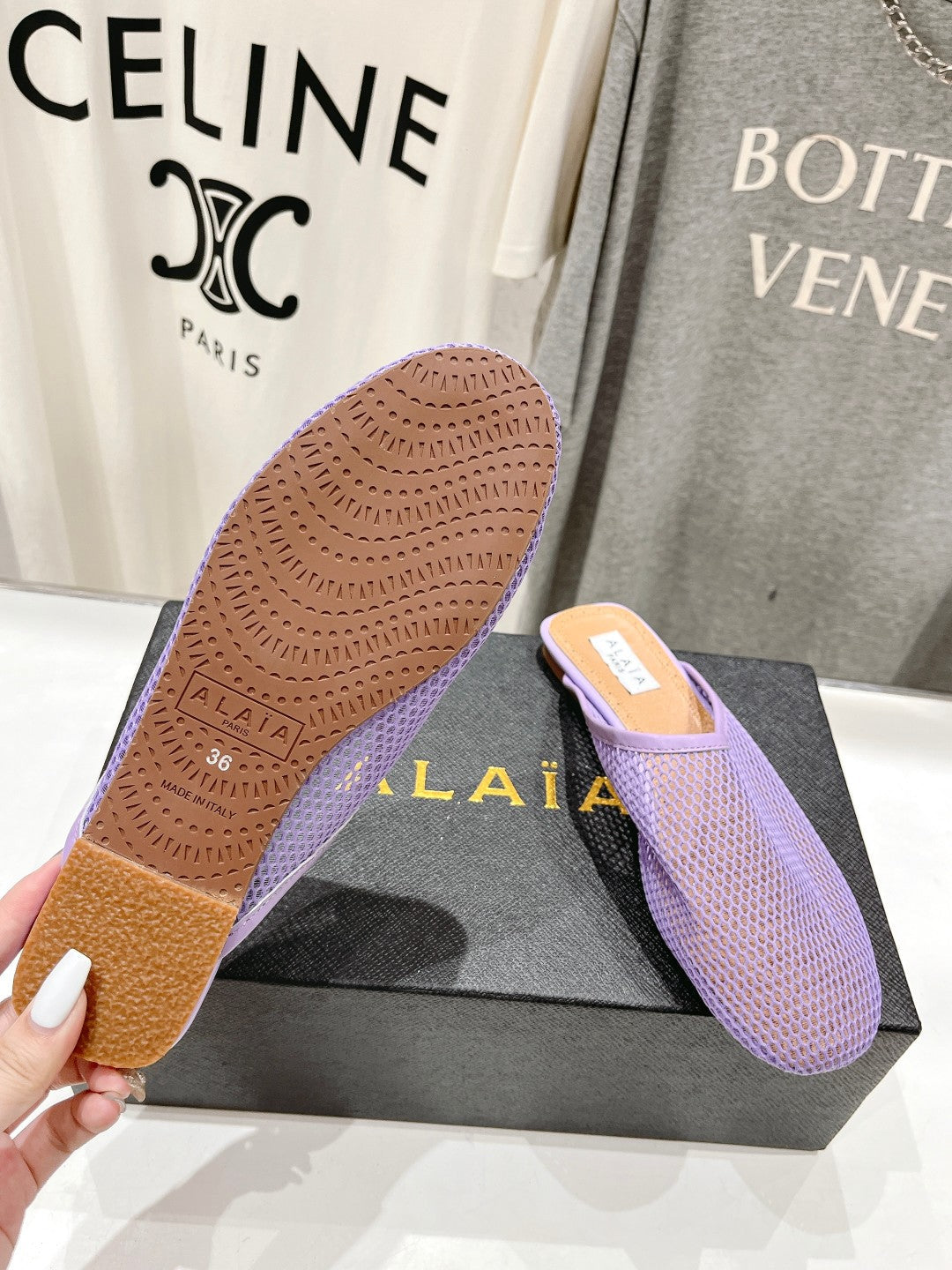 ALAIA FLAT MULES IN LIGHT PURPLE MESH FISHNET
