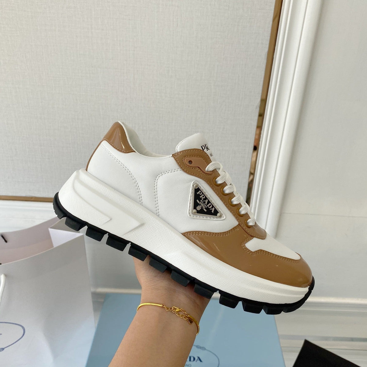 PRADA 25S THICK SOLE SNEAKER IN WHITE AND BROWN CALFSKIN