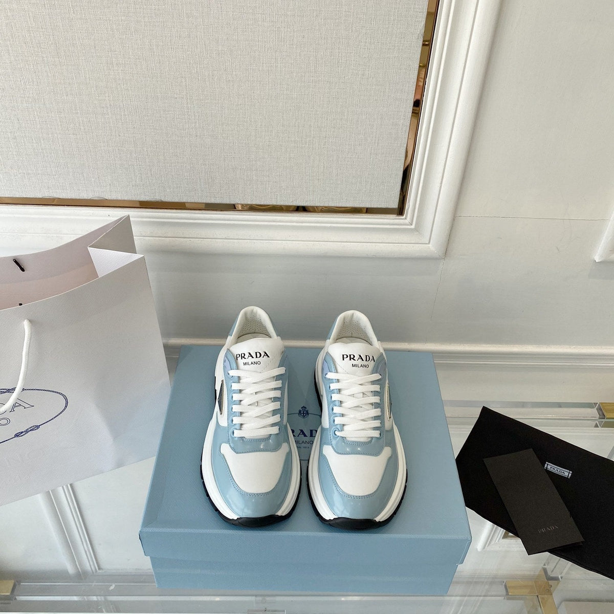 PRADA 25S THICK SOLE SNEAKER IN WHITE AND LIGHT BLUE CALFSKIN