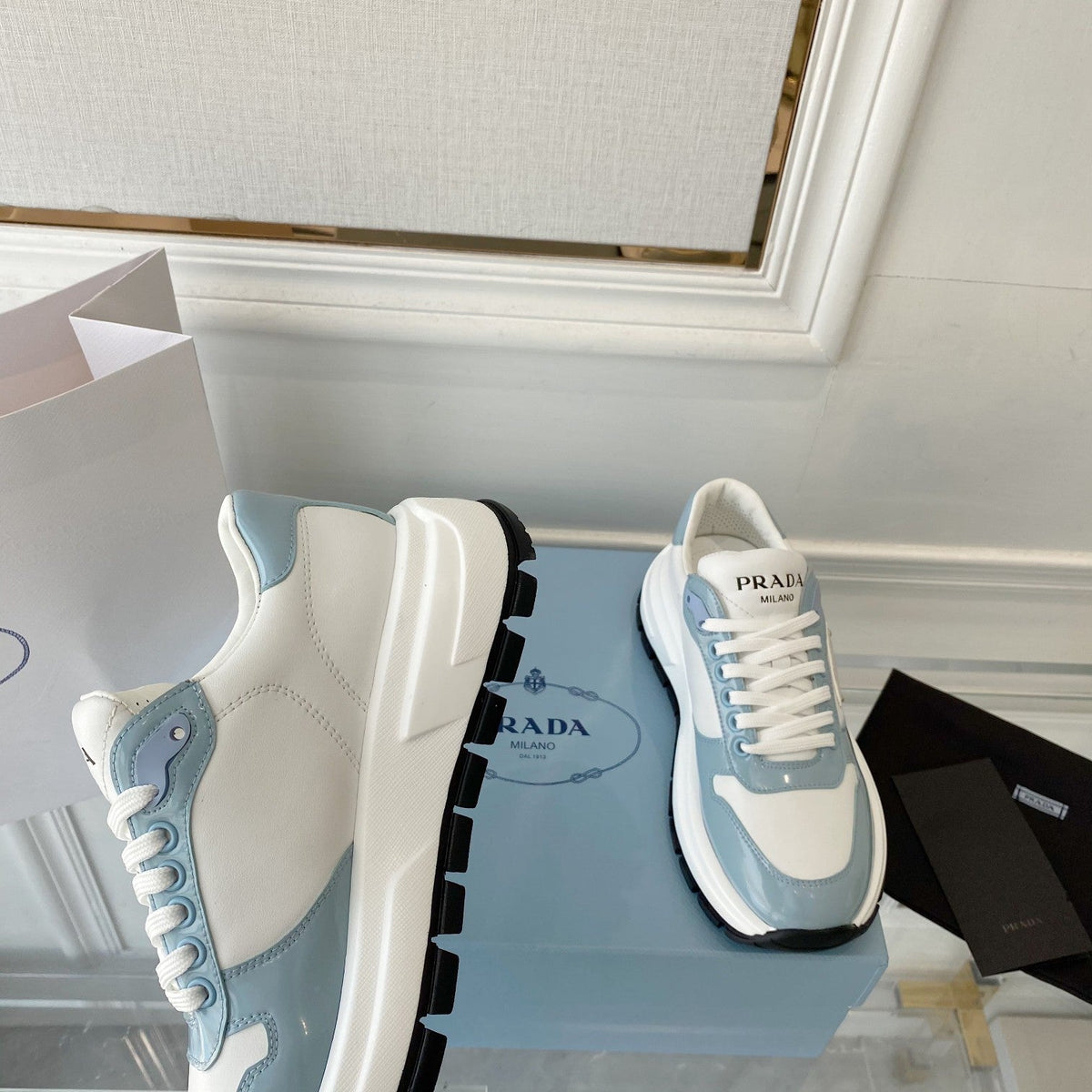 PRADA 25S THICK SOLE SNEAKER IN WHITE AND LIGHT BLUE CALFSKIN