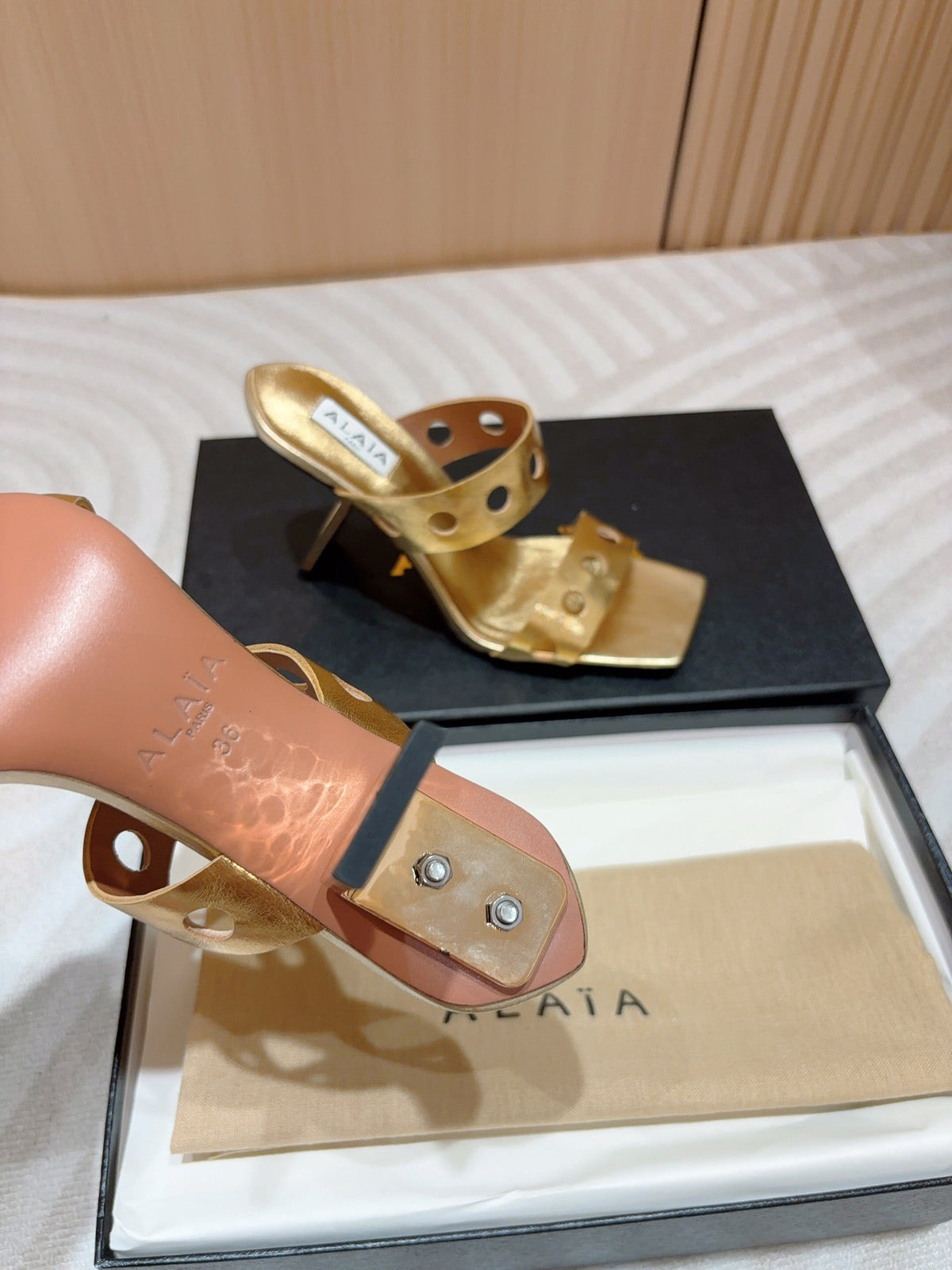 ALAIA TWO-STRAPS HIGH HEEL SANDALS IN GOLDEN PATENT LAMBSKIN