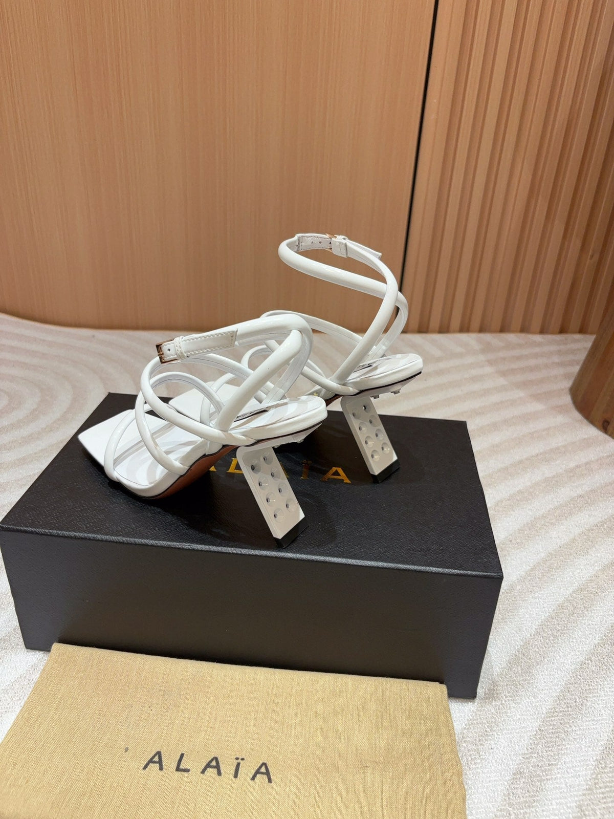 ALAIA THREE-STRAPS HIGH HEEL SANDALS IN WHITE PATENT LAMBSKIN