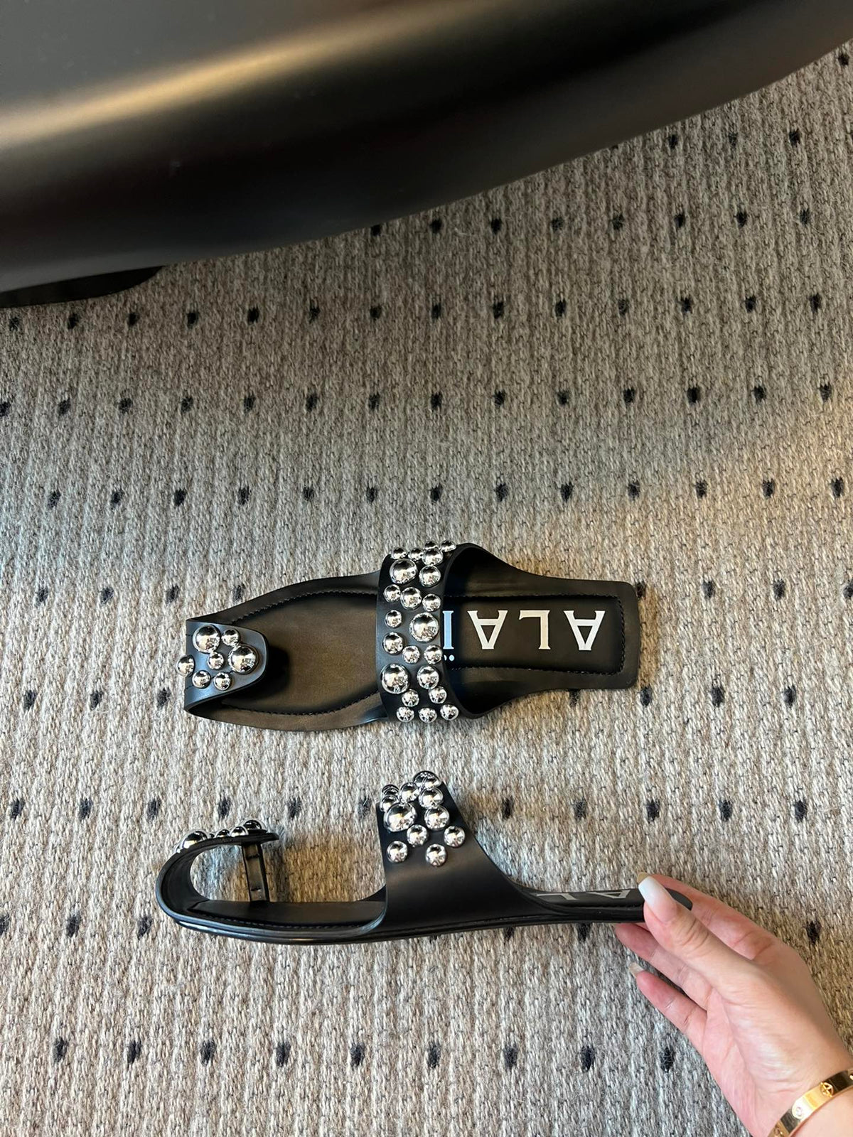 ALAIA FOLDED FLAT MULES WITH SPHERES ON BLACK CALFSKIN