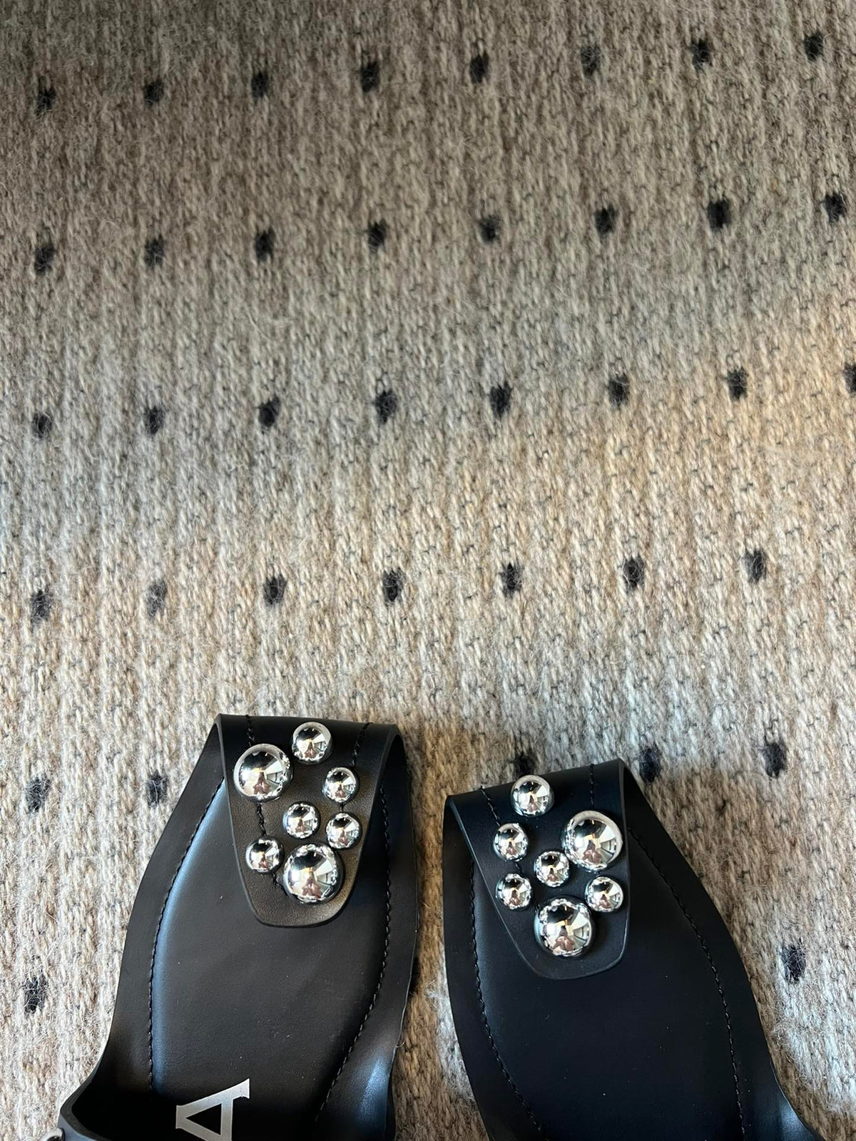 ALAIA FOLDED FLAT MULES WITH SPHERES ON BLACK CALFSKIN