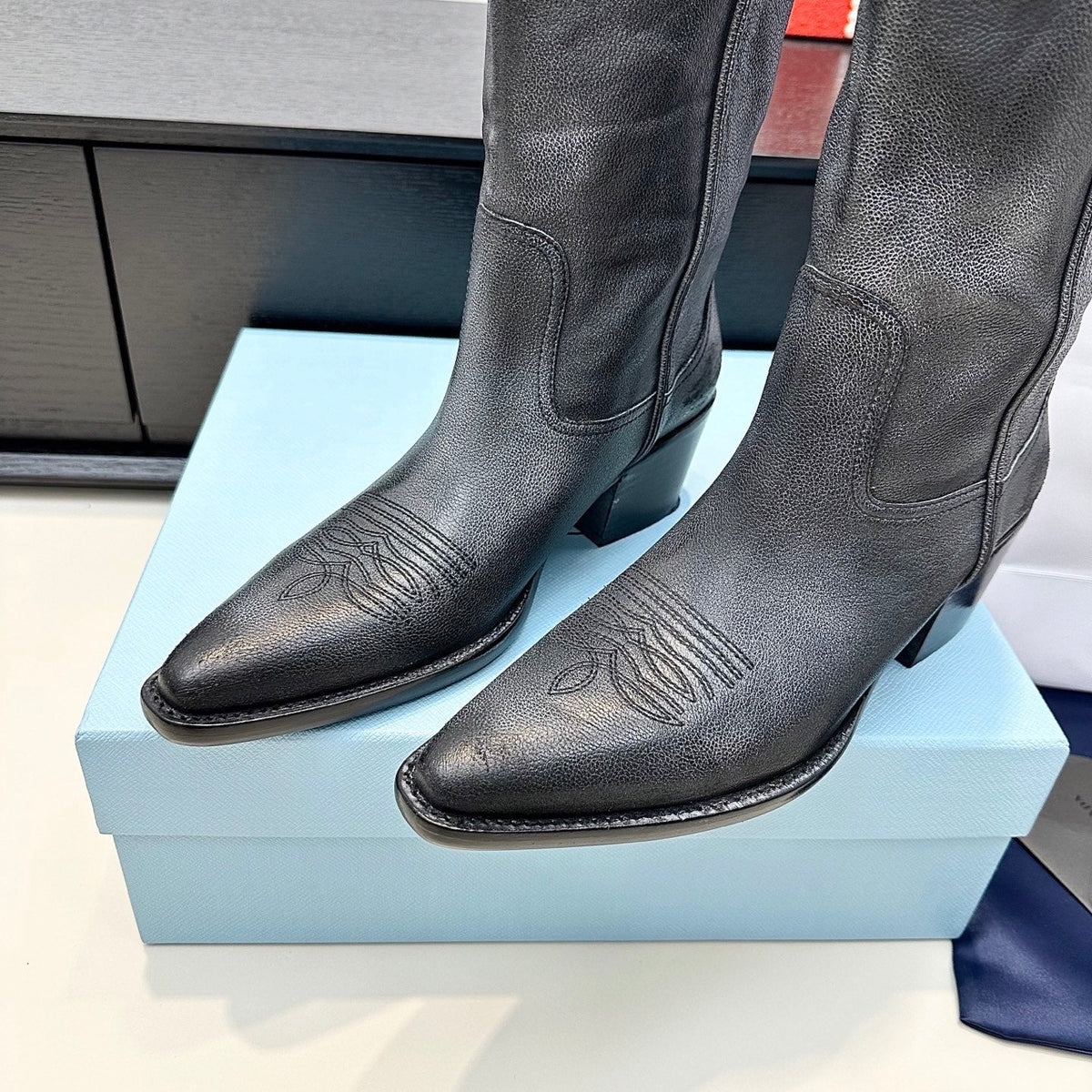 PRADA 25S POINTED-TOE LOW-CUT BOOTS IN BLACK COWHIDE