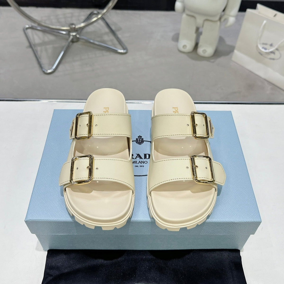 PRADA 25S STRAP SLIDES 30MM IN CREAM CALFSKIN GOLD HARDWARE