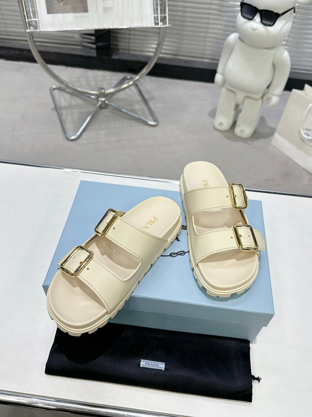 PRADA 25S STRAP SLIDES 30MM IN CREAM CALFSKIN GOLD HARDWARE
