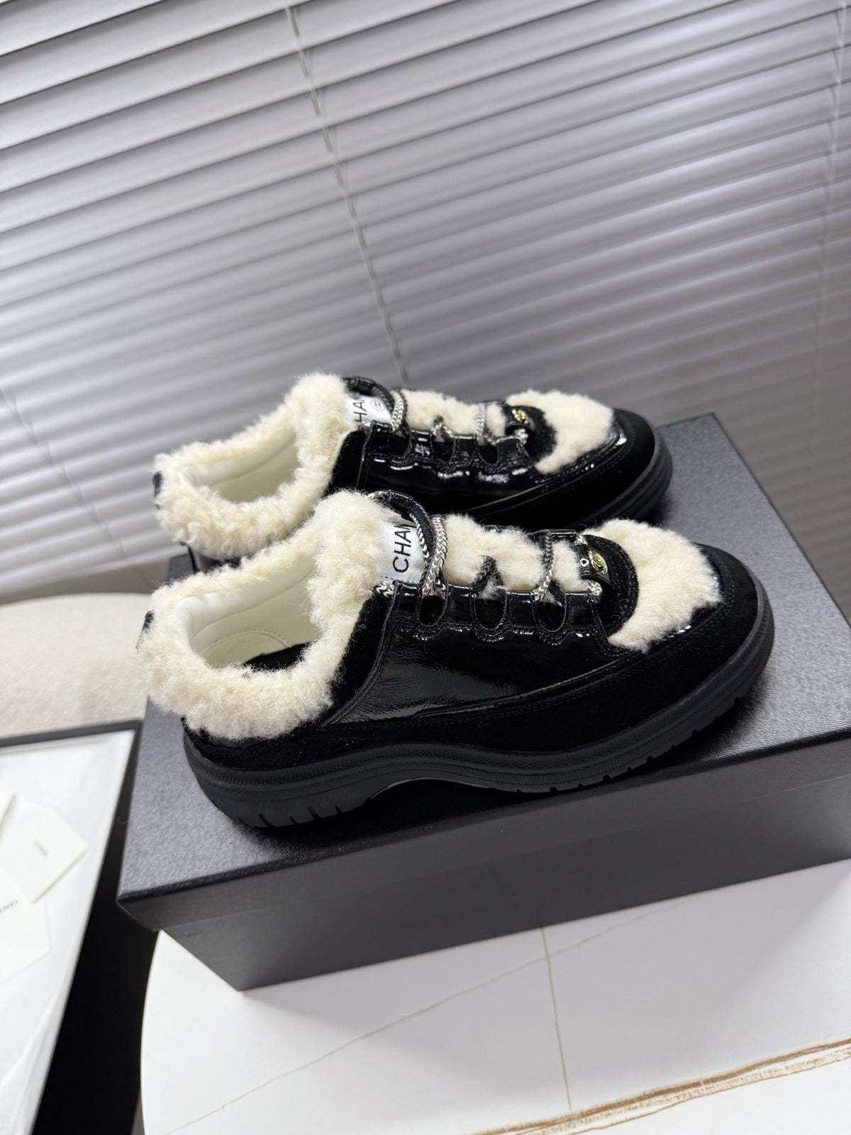 CHANEL 25S SNEAKERS WITH FUR ACCENTS 35MM IN BLACK CALFSKIN