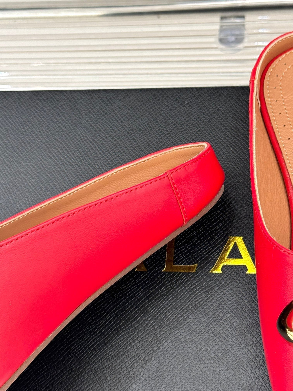 ALAIA FLAT MULE IN CRIMSON RED LAMBSKIN WITH GOLD HARDWARE