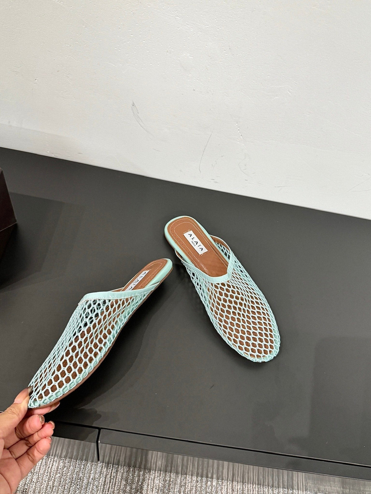 ALAIA FLAT MULES IN LIGHT BLUE MESH FISHNET