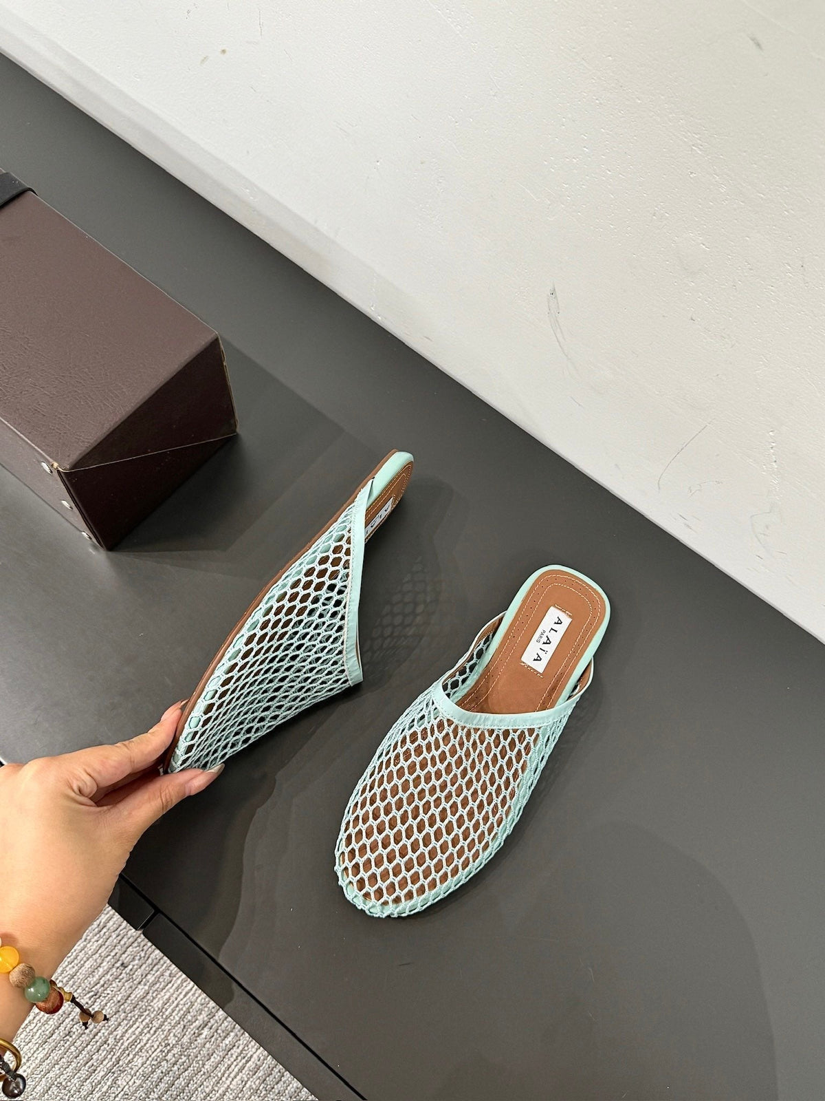 ALAIA FLAT MULES IN LIGHT BLUE MESH FISHNET