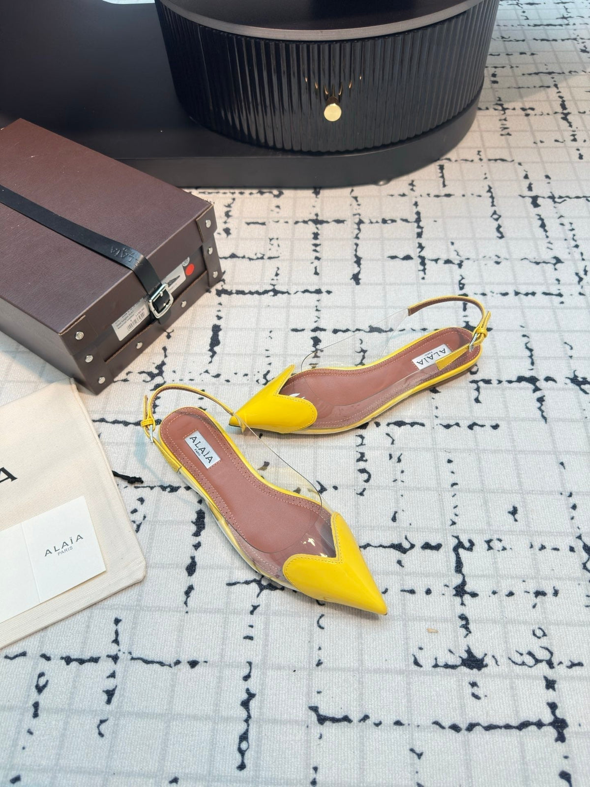ALAIA FLAT SLINGBACK IN YELLOW PATENT CALFSKIN AND FILM