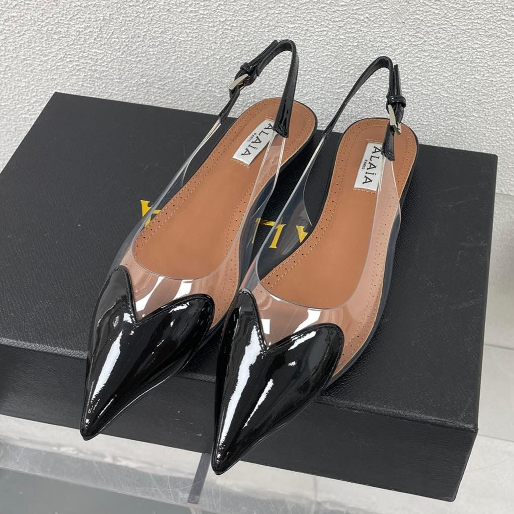 ALAIA LE COEUR FLAT SLINGBACKS IN BLACK PATENT LAMBSKIN