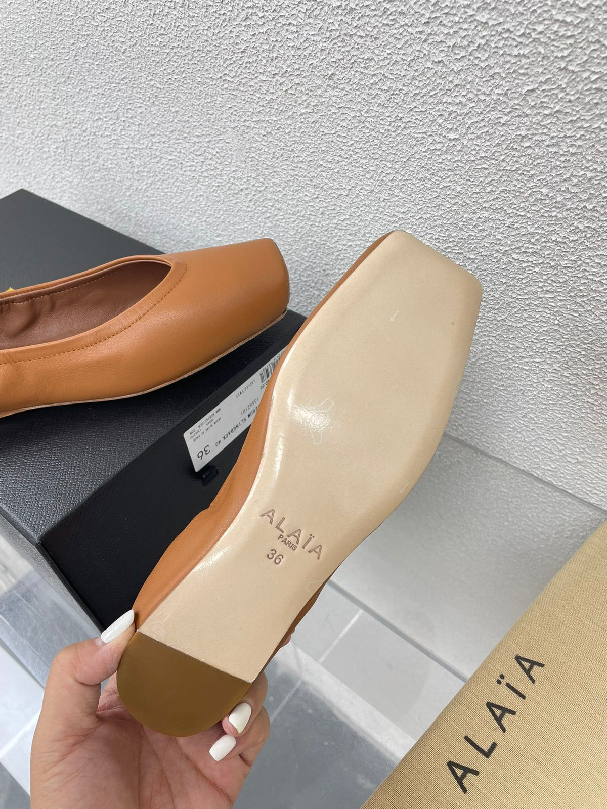 ALAIA BALLET FLATS IN COPPER BROWN CALFSKIN