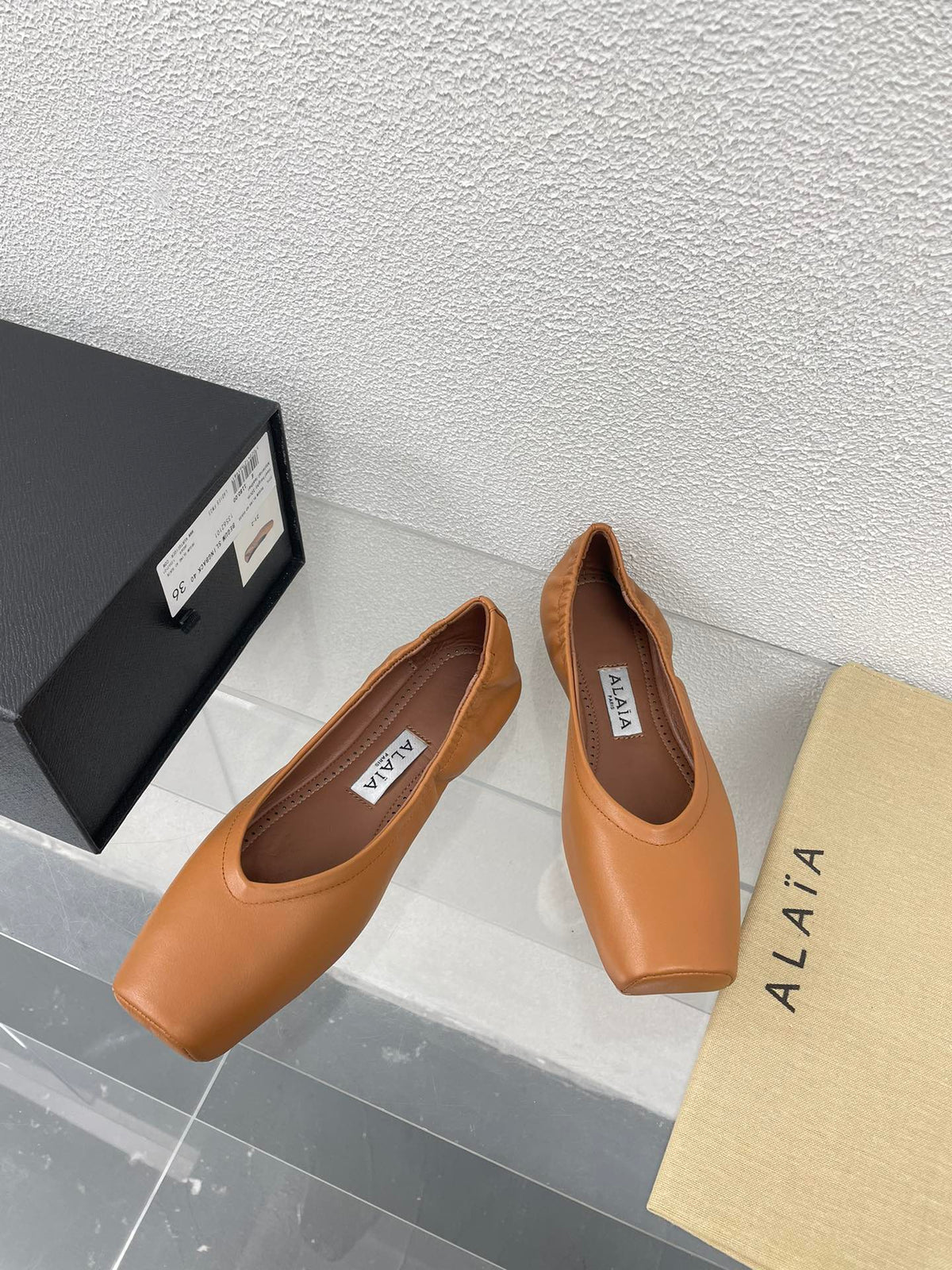 ALAIA BALLET FLATS IN COPPER BROWN CALFSKIN