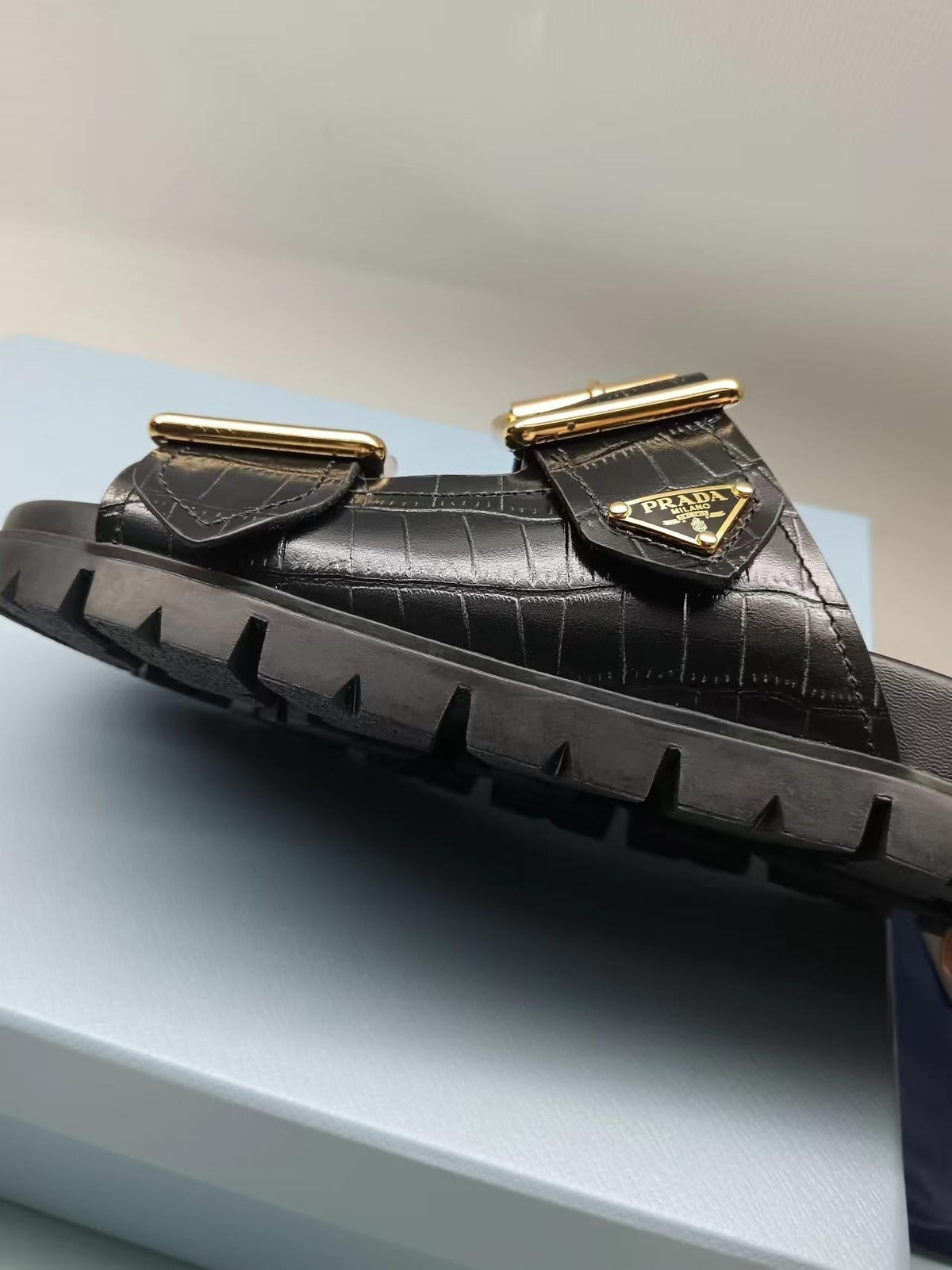 PRADA 26S STRAP SLIDES IN BLACK CROC EMBOSSED CALFSKIN GOLD HARDWARE