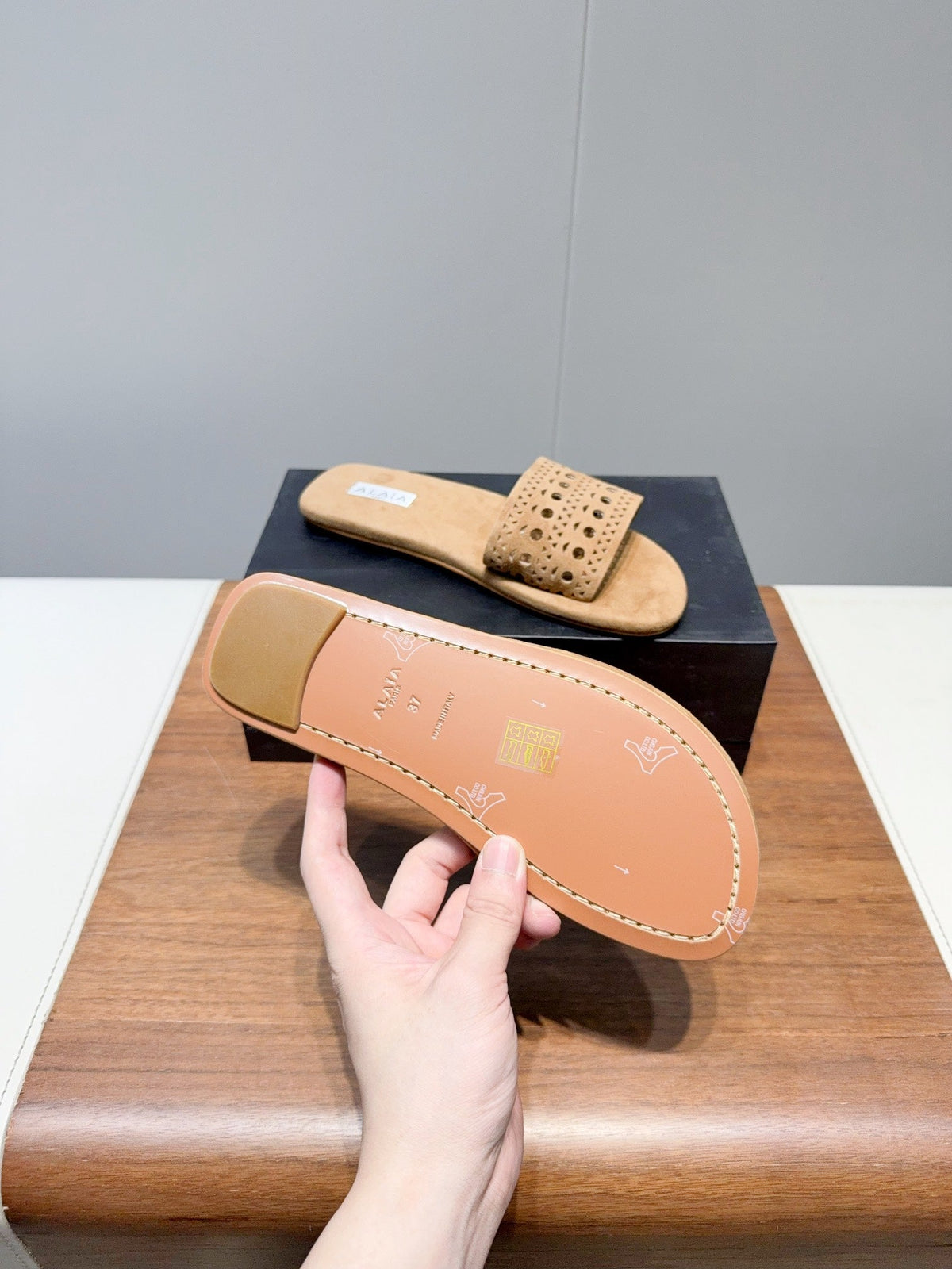 ALAIA FLAT SANDALS WITH PERFORATED STRAPS 25S IN BEIGE SUEDE