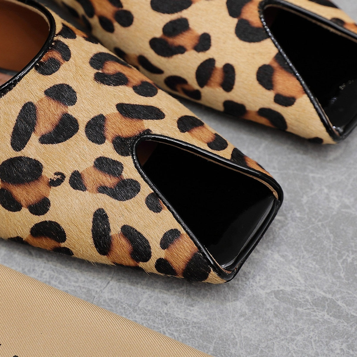 ALAIA FLAT MULE IN LEOPARD LAMBSKIN
