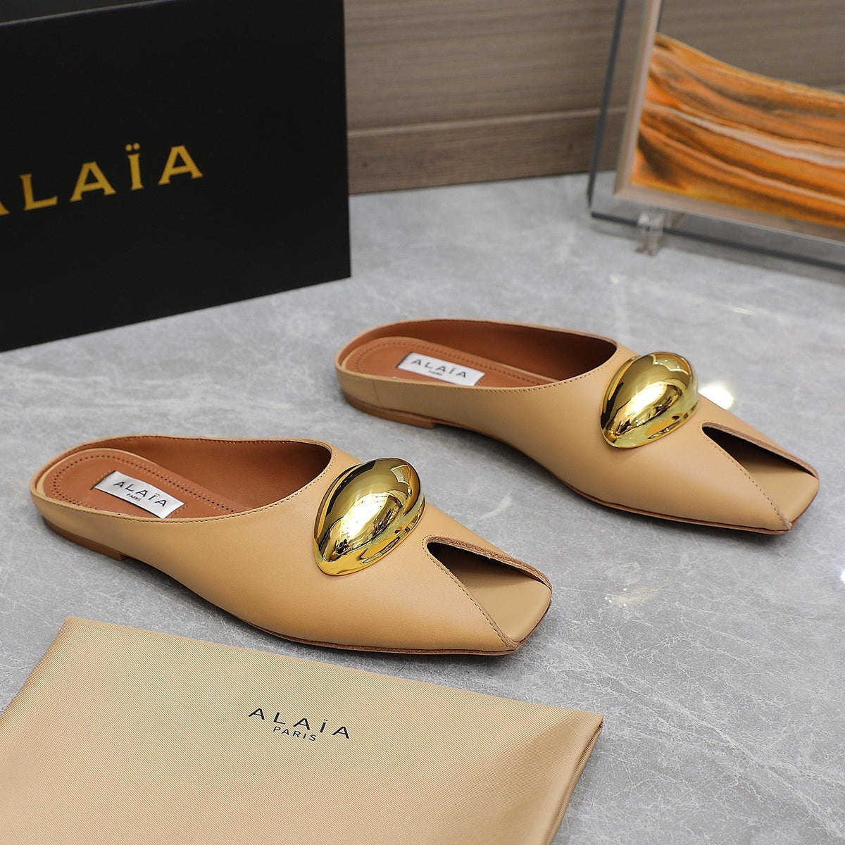 ALAIA FLAT MULE IN SEPIA TAN LAMBSKIN WITH GOLD HARDWARE
