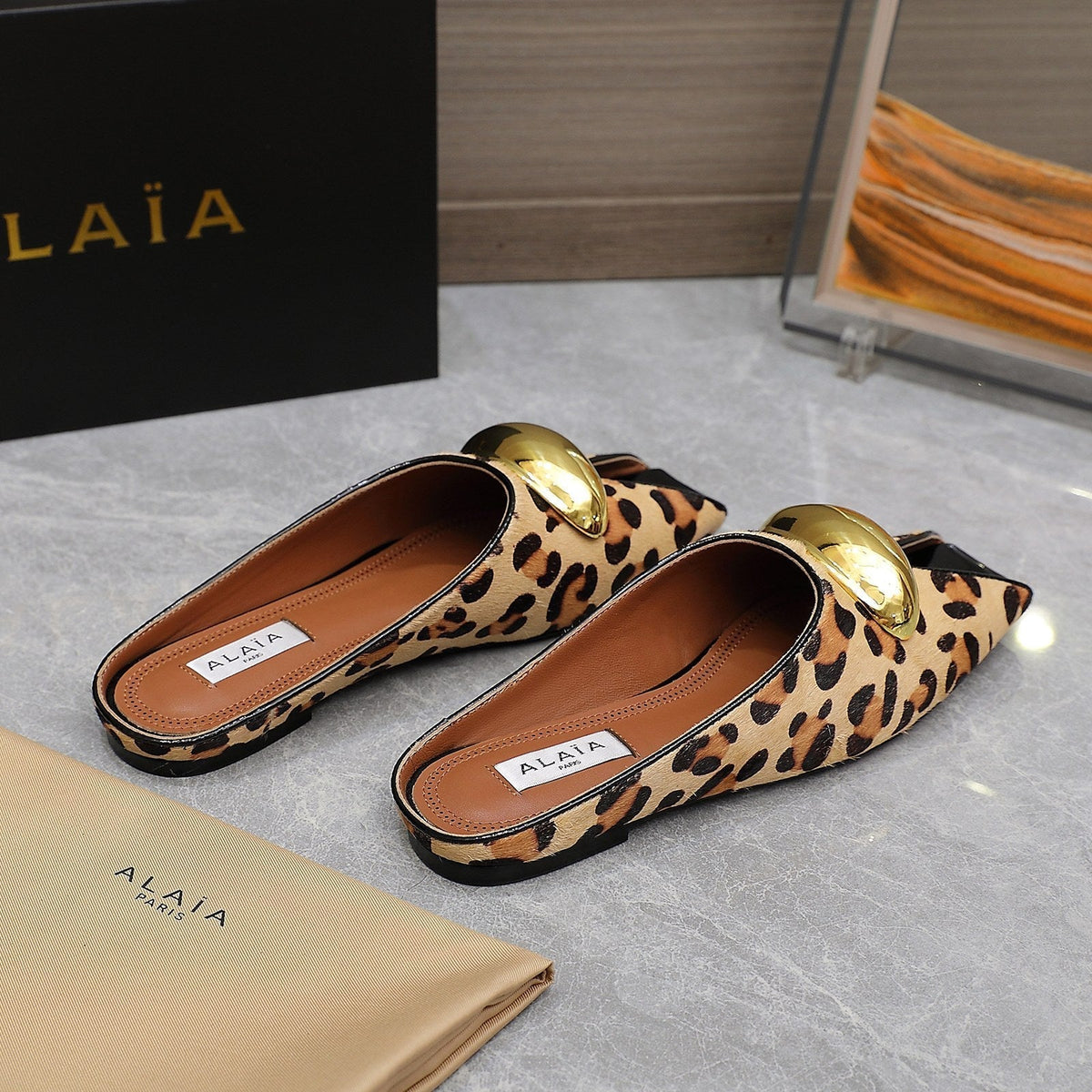 ALAIA FLAT MULE IN LEOPARD LAMBSKIN WITH GOLD HARDWARE