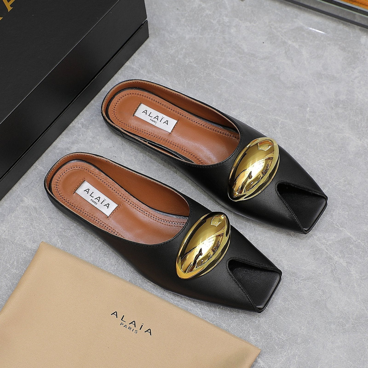 ALAIA FLAT MULE IN BLACK LAMBSKIN WITH GOLD HARDWARE