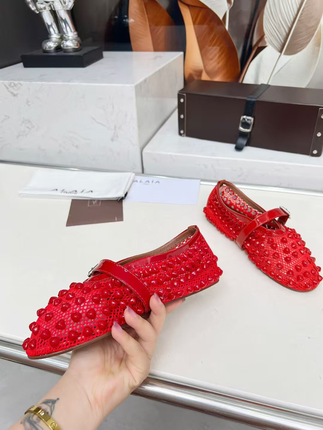 ALAIA MARY JANE SHOES IN CHERRY RED STUDDED FISHNET MESH AND CALFSKIN
