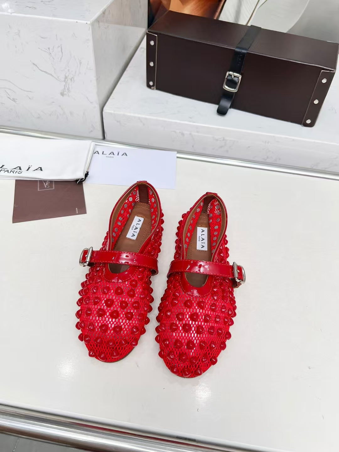 ALAIA MARY JANE SHOES IN CHERRY RED STUDDED FISHNET MESH AND CALFSKIN
