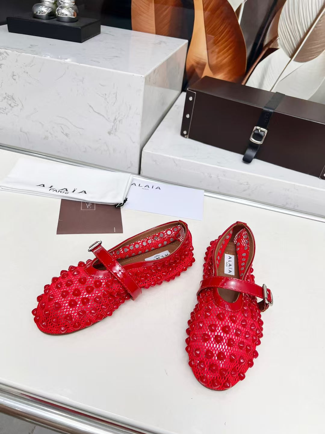 ALAIA MARY JANE SHOES IN CHERRY RED STUDDED FISHNET MESH AND CALFSKIN