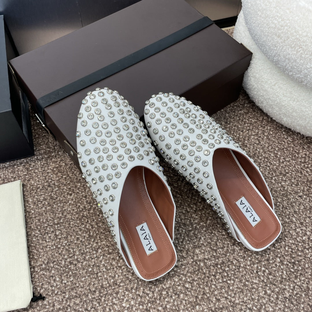 ALAIA FLAT MULES 25S IN WHITE LAMBSKIN EMBELLISHED WITH CRYSTALS