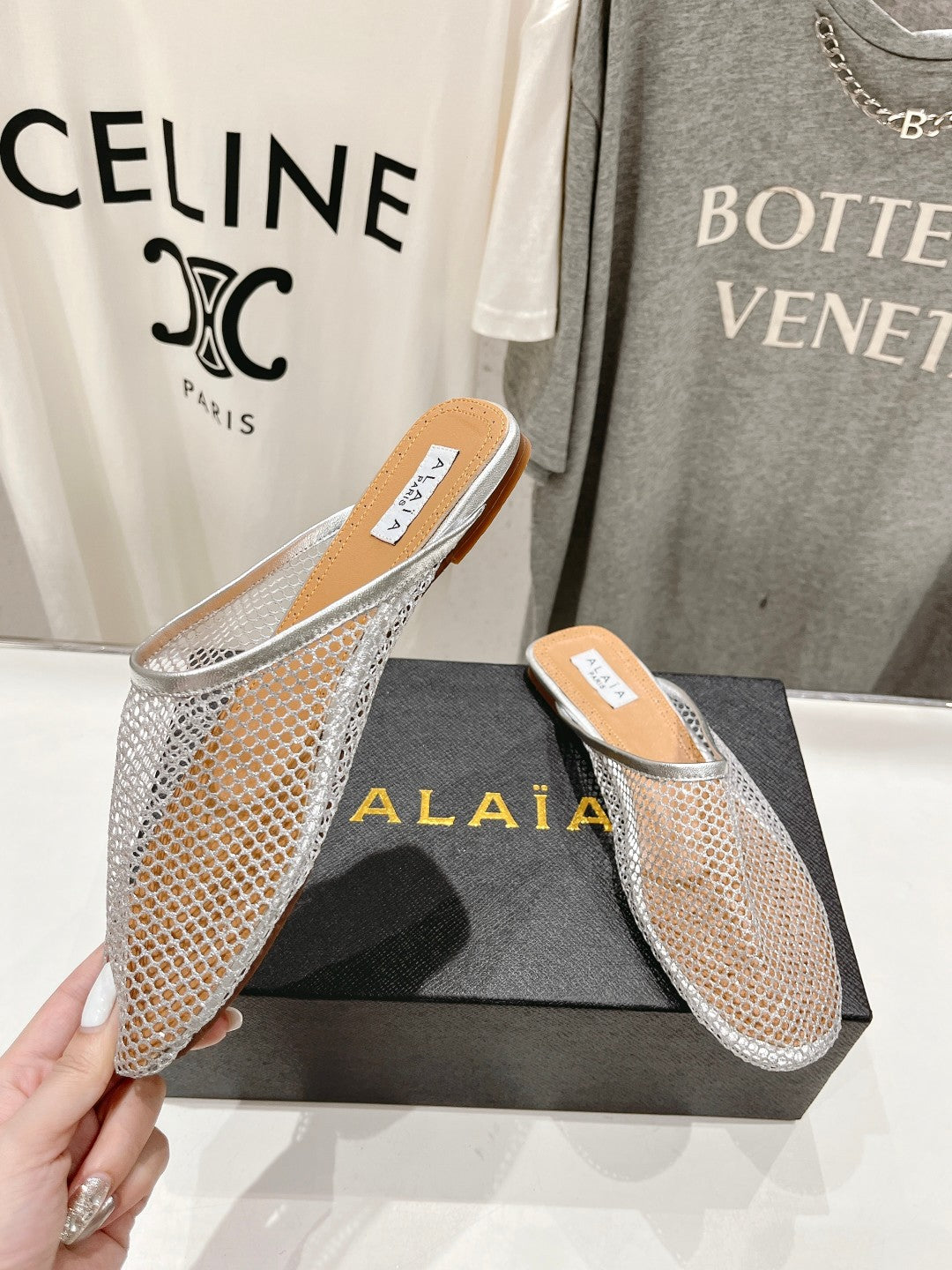 ALAIA FLAT MULES IN SILVER MESH FISHNET