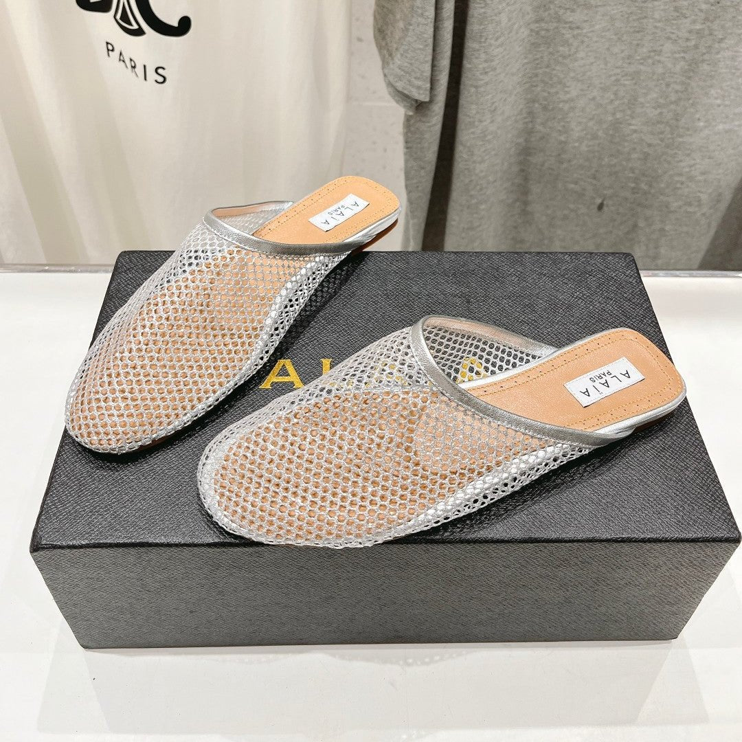 ALAIA FLAT MULES IN SILVER MESH FISHNET