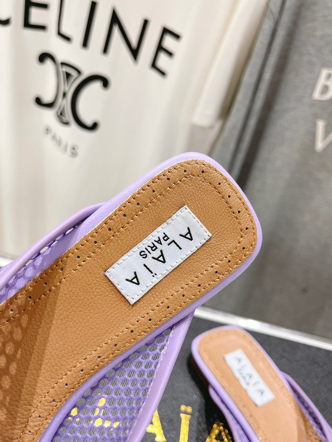 ALAIA FLAT MULES IN LIGHT PURPLE MESH FISHNET