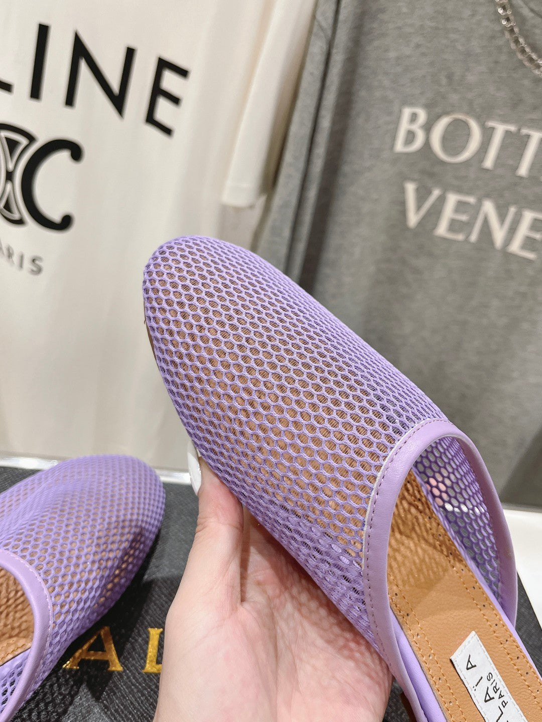 ALAIA FLAT MULES IN LIGHT PURPLE MESH FISHNET